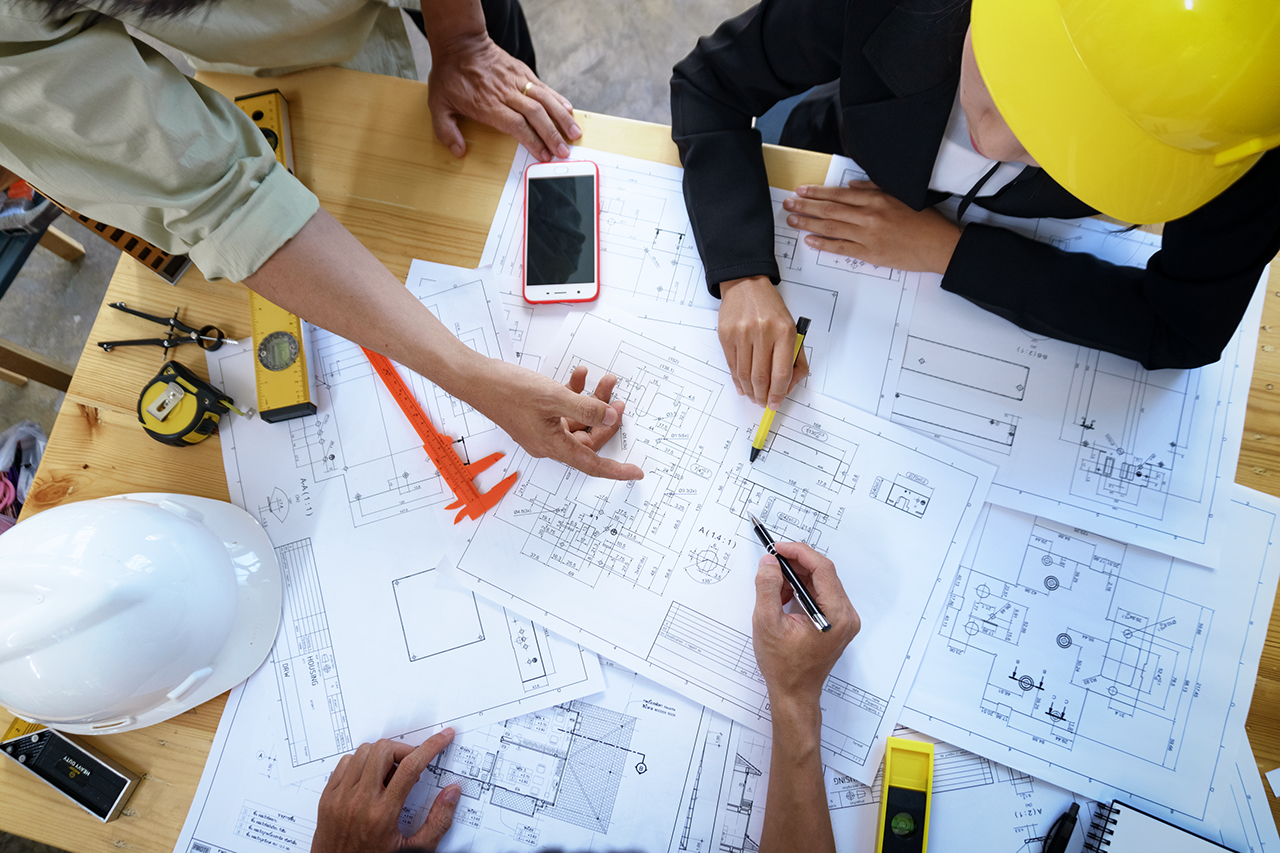 engineer people meeting working and pointing at a drawings in office for discussing. Engineering tools and construction concept.; Shutterstock ID 704715226; Purchase Order: -